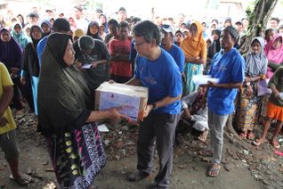 A woman and other residents who survived the tsunami disaster received an aid package from the SPF in Sumber Jaya village; Banten; Indonesia; February 17; 2019. SECOURS POPULAIRE FRANCAIS/Arif Ariadi