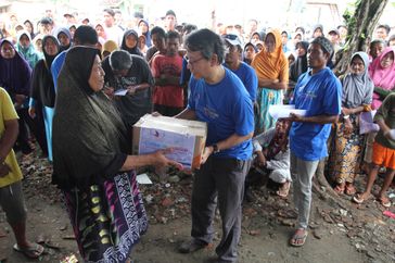 A woman and other residents who survived the tsunami disaster received an aid package from the SPF in Sumber Jaya village; Banten; Indonesia; February 17; 2019. SECOURS POPULAIRE FRANCAIS/Arif Ariadi
