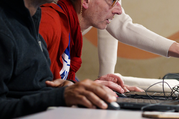 des participants à un atelier numérique sont penchés sur leur écran avec concentration